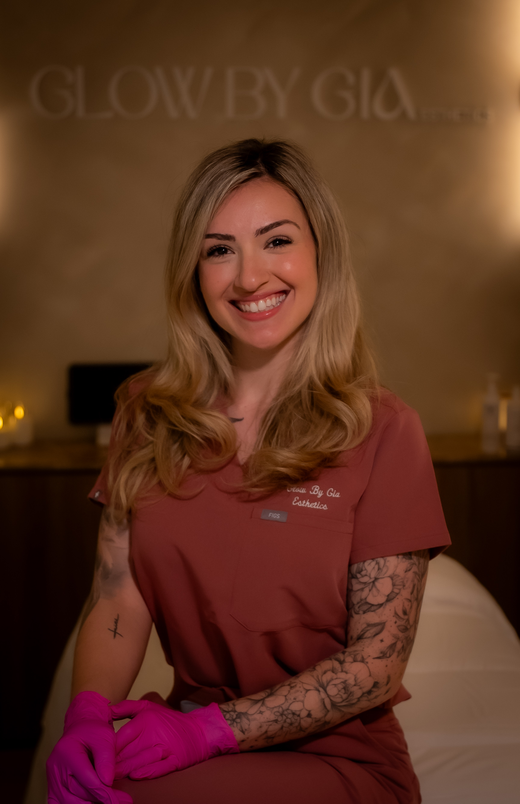 Gia in Glow by Gia esthetics scrubs at the studio