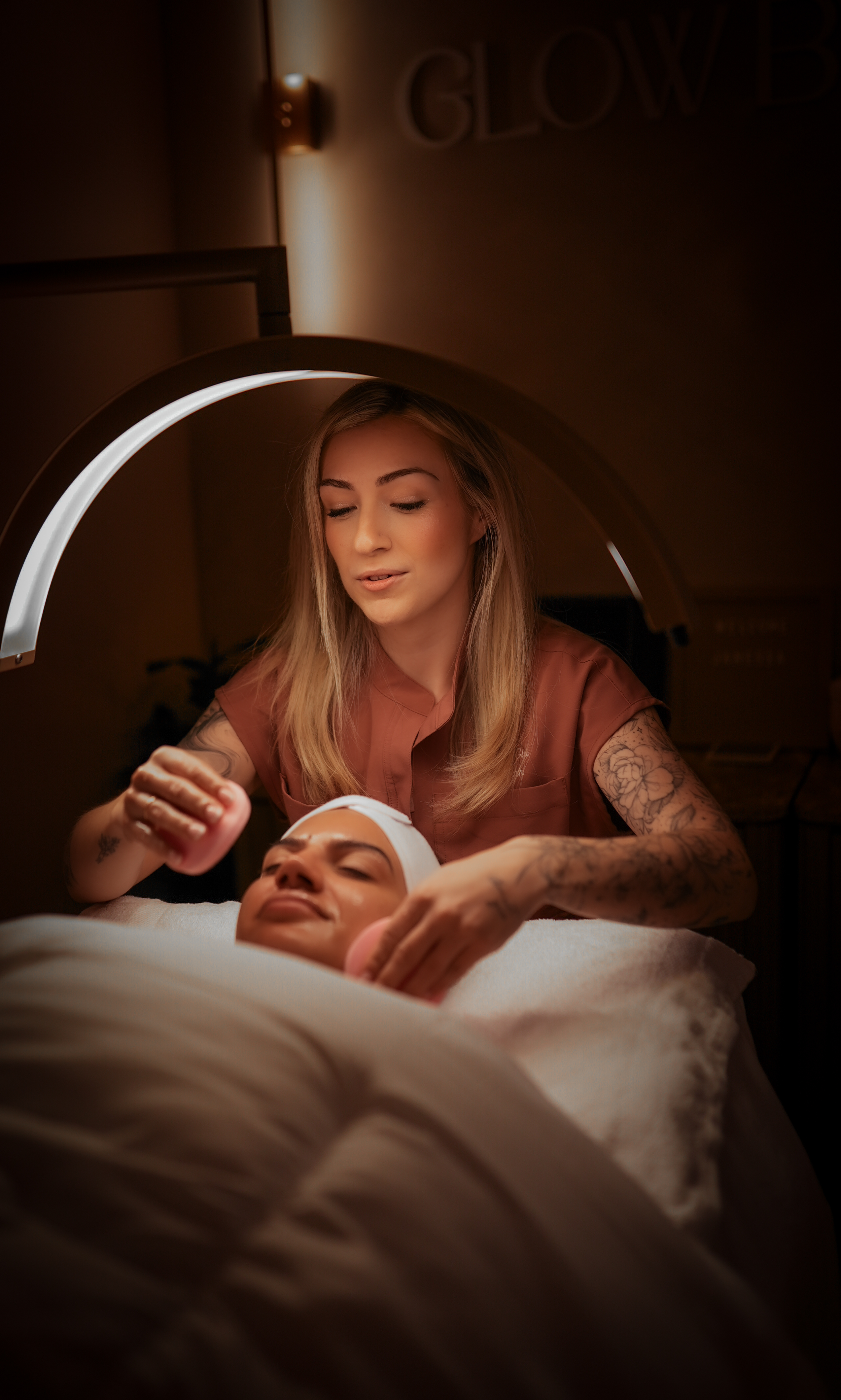 Gia performing a facial treatment at Glow by Gia